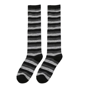 Close-up view of black and grey horizontal striped knee-high socks on white background