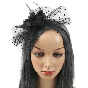 Detailed macro view of vintage black mesh fascinator headband with feathers and flower