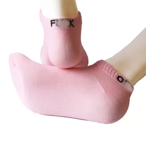 Close-up detail of pink ankle socks with black letter print on the elastic cuff