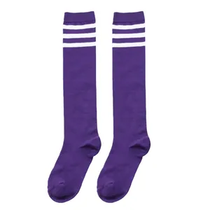 Detail view of purple children's knee-high tube socks with white striped accents.