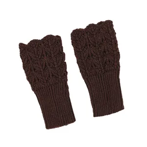 Detailed macro view of the brown chunky leaf knit pattern on fingerless arm warmers