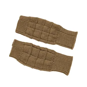 Close-up detail of brown knitted fingerless gloves featuring a textured checkerboard pattern