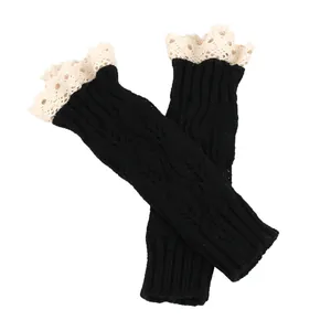 Detailed view of black cable knit arm warmers featuring delicate white lace trim