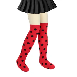 Close-up detail of children red and black polka dot ladybug over the knee socks