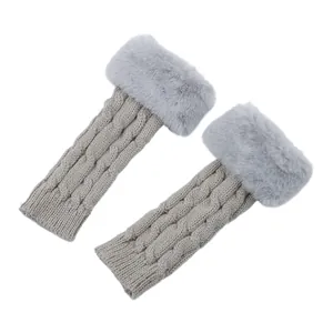 Detailed macro view of grey cable knit fingerless gloves with elegant faux fur trim