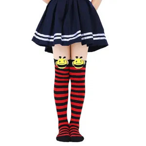 Detail of children's bee socks with red and black stripes and cute plush bee dolls