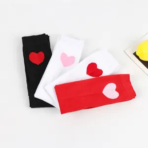 Detailed view of Valentine's Day over-the-knee socks in black, white and red colors