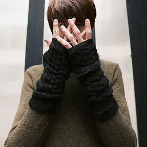 Detail view of black cable knit fingerless long arm warmers on model