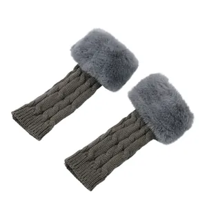 Detail of cable knit fingerless warmers featuring plush grey faux fur trim