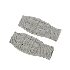 Detailed macro view of grey knitted fingerless gloves featuring a stylish checkered pattern