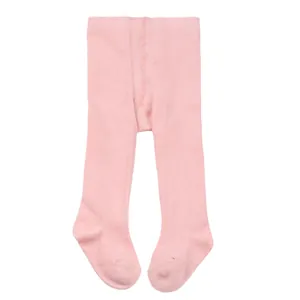 Close-up view of soft pink infant footed tights featuring a comfortable elastic waistband