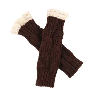 Detail view of brown knit fingerless gloves with lace trim and leaf pattern