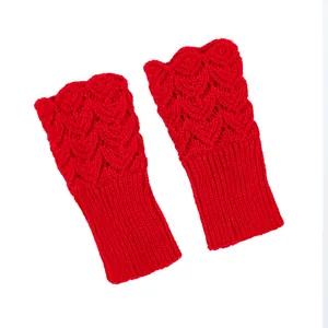Detail view of red knitted fingerless gloves with heart-shaped openwork pattern