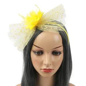 Vintage yellow floral fascinator headband with elegant feathers and polka dot mesh detail