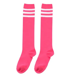Detailed shot of bright pink knitted knee-high socks with three white stripes at the top