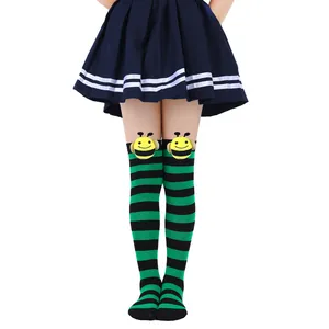 Close-up detail of children's green and black striped socks with cute 3D bee doll ornaments