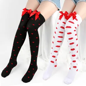 Cute thigh-high socks with red bows featuring heart and lip prints for Valentine's
