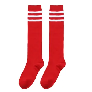 Detailed view of red children's knee-high socks featuring decorative triple white stripes