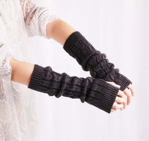 Detail view of dark brown cable knit fingerless arm warmers for autumn and winter