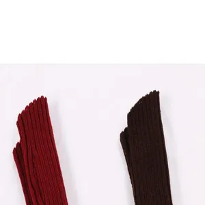 Close-up macro view showing the ribbed knit texture of acrylic arm warmers in red and brown