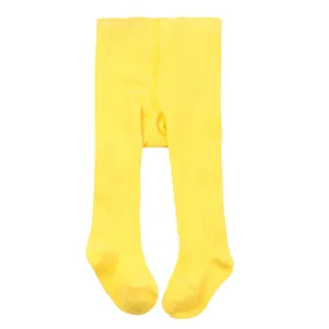 Close-up view of bright yellow infant footed leggings featuring soft ribbed knit fabric