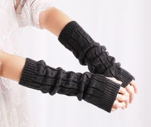 Macro detail of long charcoal grey cable knit arm warmers with a cozy texture.