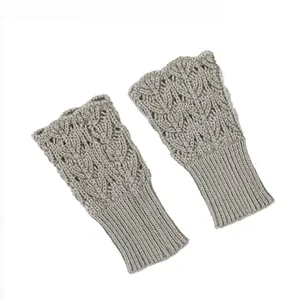 Close-up view of elegant heart-shaped hollow knit pattern on grey fingerless gloves