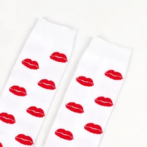 Close-up of white over-the-knee socks with vibrant red lip pattern for Valentine's Day.