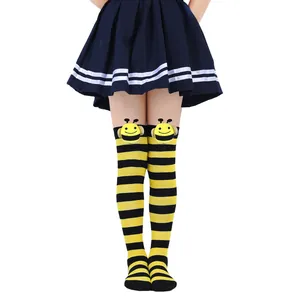 Detailed macro view of children's striped bee over-the-knee socks with cute bee dolls.