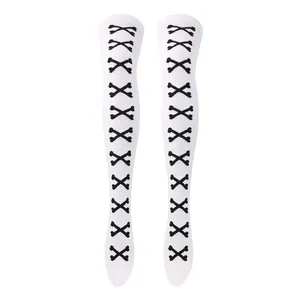 Detalle de calcetines blancos sobre la rodilla con patrón de huesos cruzados para Halloween
