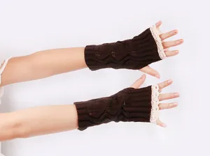 Detail shot of brown cable-knit fingerless gloves featuring elegant white lace trim