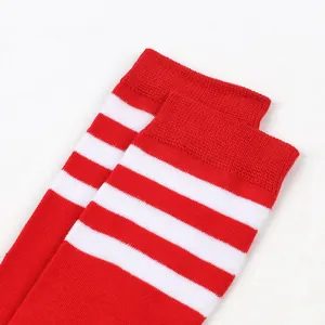 Detailed view of red and white striped kids socks featuring high-quality knitted three-bar design
