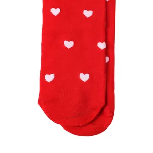 Detailed close-up view of red Valentine's Day over-the-knee socks with heart patterns