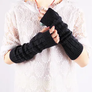 Detailed close-up view of black cable knit fingerless arm warmers for autumn and winter