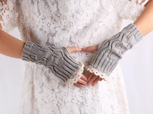 Detail of gray knitted fingerless gloves with delicate white lace trim on wrist