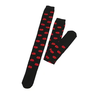 Detailed view of black over-the-knee socks featuring a vibrant repeating red lip pattern