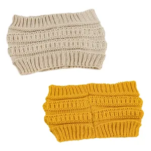 Detailed view of two wide cable knit winter headbands in beige and yellow colors