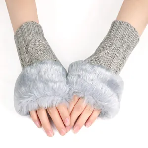 Detailed close-up of grey knitted fingerless gloves with luxurious soft faux fur trim