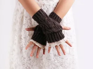 Detailed view of dark brown knitted fingerless gloves with elegant cream lace trim.