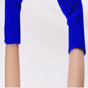 Bright blue knitted arm warmers detail showing the soft texture and snug fit on arms
