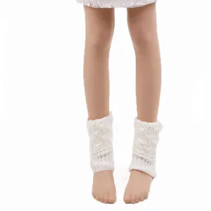 Close-up of white cable knit short leg warmers showing intricate hollow-out texture.