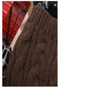 Macro view of brown cable knit pattern on warm winter fingerless arm warmers