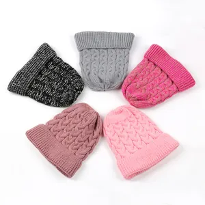 Detailed view of five multi-colored warm cable knit beanies arranged in a circle layout