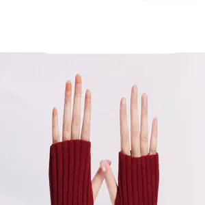 Detailed shot of burgundy ribbed knit fingerless arm warmers showing the open finger design