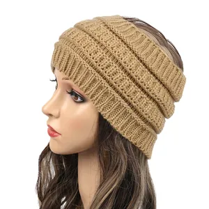 Close-up detail of a wide camel knitted winter headband for women with soft cable texture