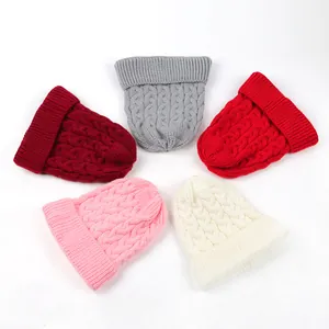 Variety of cable knit beanies in multiple colors including red, grey, and pink