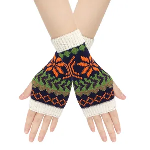 Close-up view of snowflake pattern knitted fingerless gloves worn by model