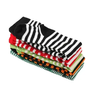 Stack of colorful striped toddler leggings for Christmas and Halloween festivities.