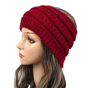 Detailed view of wine red cable knit wide headband for winter warmth and fashion accessory