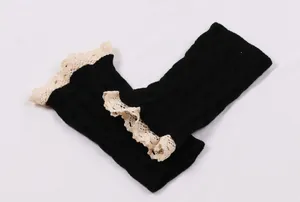 Detail showing the intricate texture and cream lace of these black leg warmers